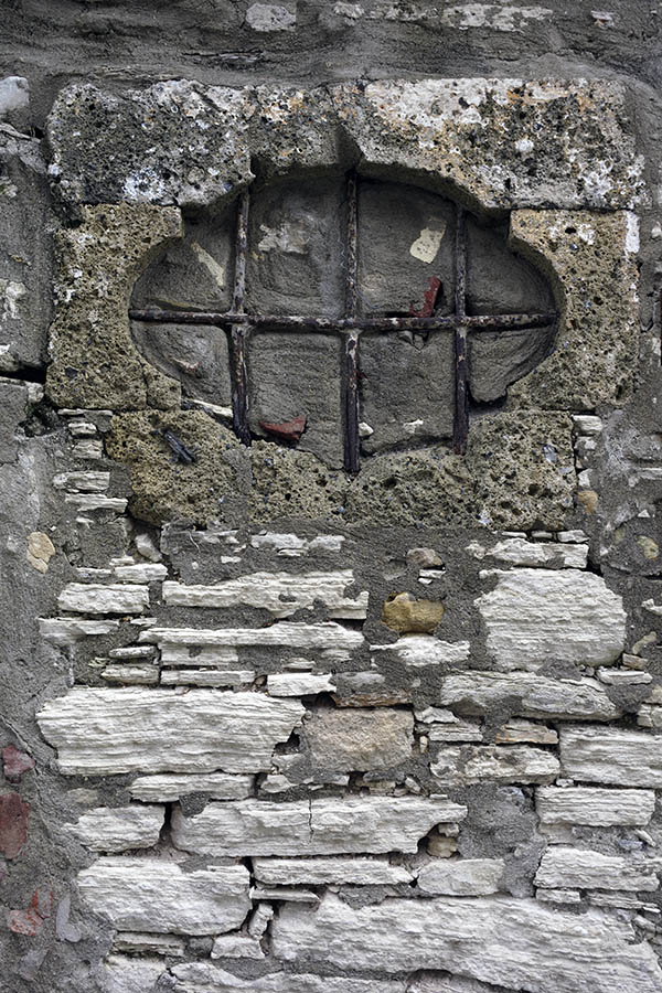 Photo 26576: No window. Grey, oval, former window blocked by cement