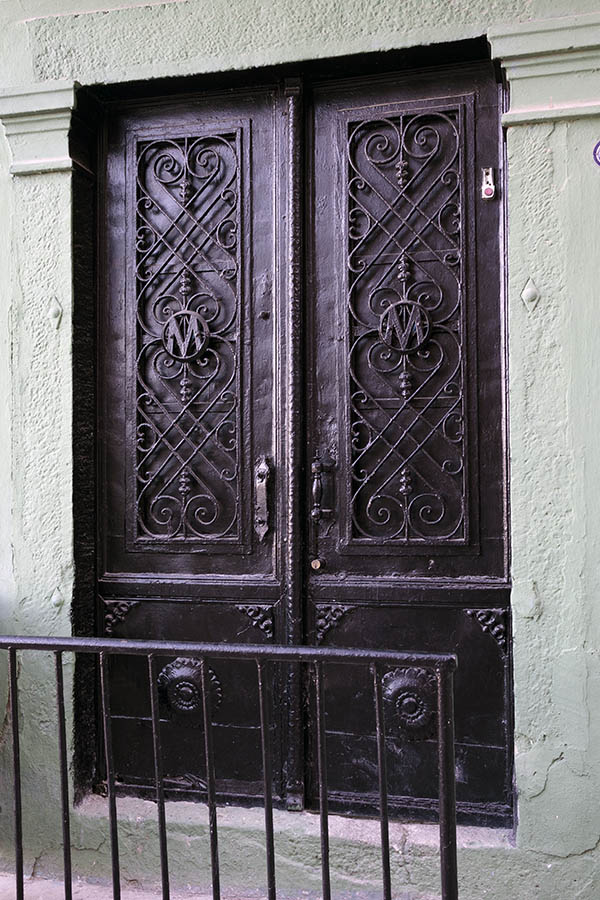 Photo 26598: Worn, black double door with lattice