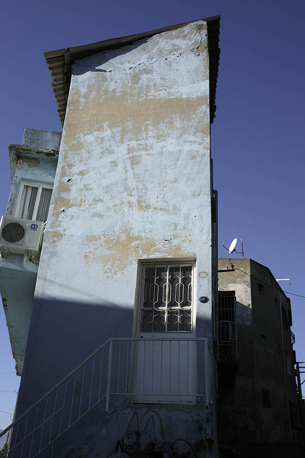 Photo 26635: Narrow, light blue facade with white, latticed door