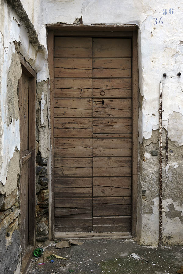 Photo 26698: Worn, narrow, brown double door of boards