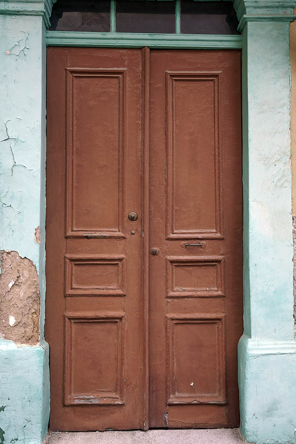 Photo 26731: Worn, brown, panelled double door with green top window