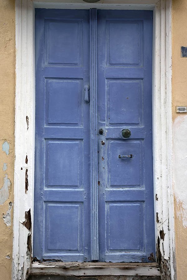 Photo 26867: Worn, panelled, light blue double door in a white frame
