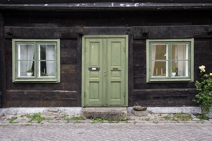 Photo 27086: Facade with green, panelled double door and two windows with two frames and four panes each