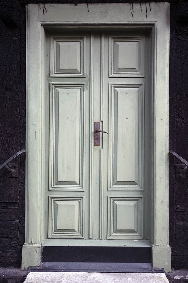 Photo 27119: Worn, panelled, light green double door with banisters