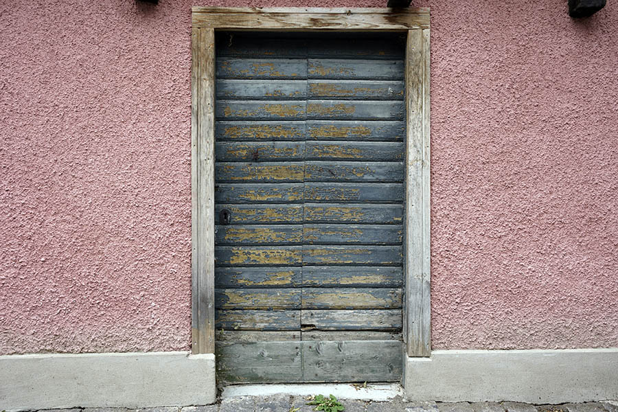 Photo 27202: Worn, teal double door made of boards in an unpainted frame
