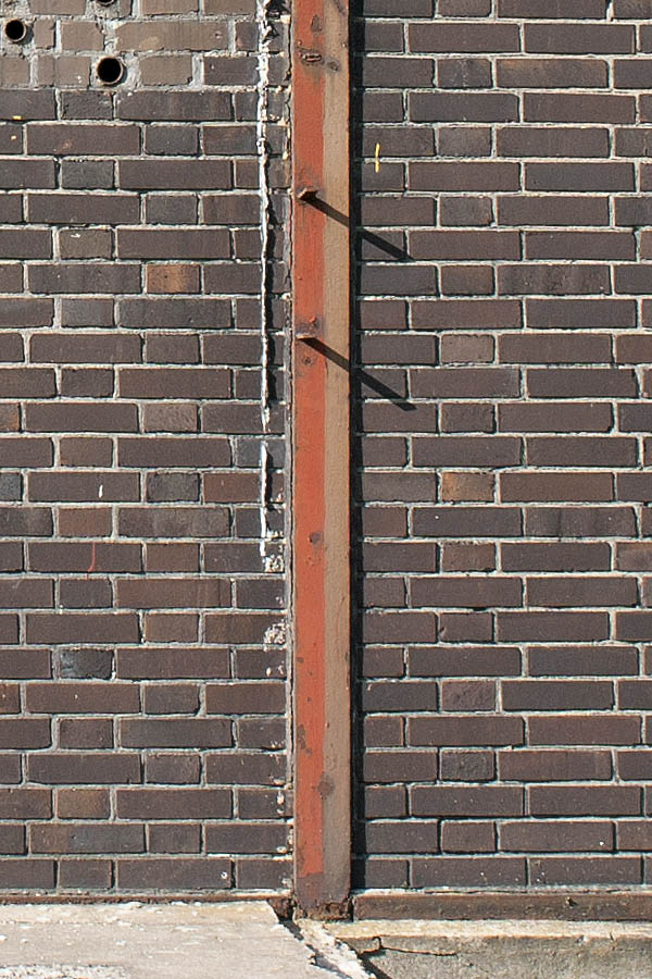 Photo 00050: Worn, brown metal door and windows facade