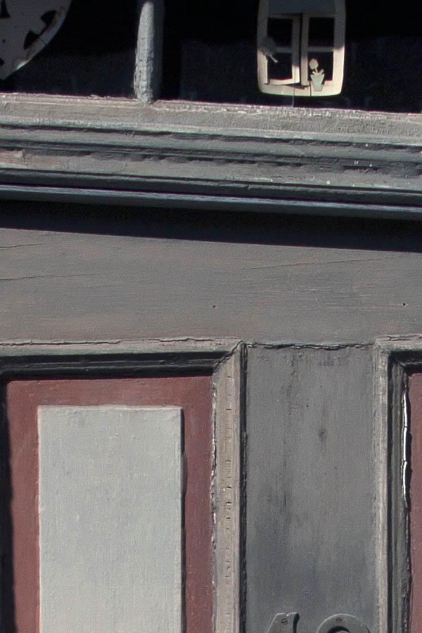 Photo 03788: Lopsided, panelled brown, grey and red door