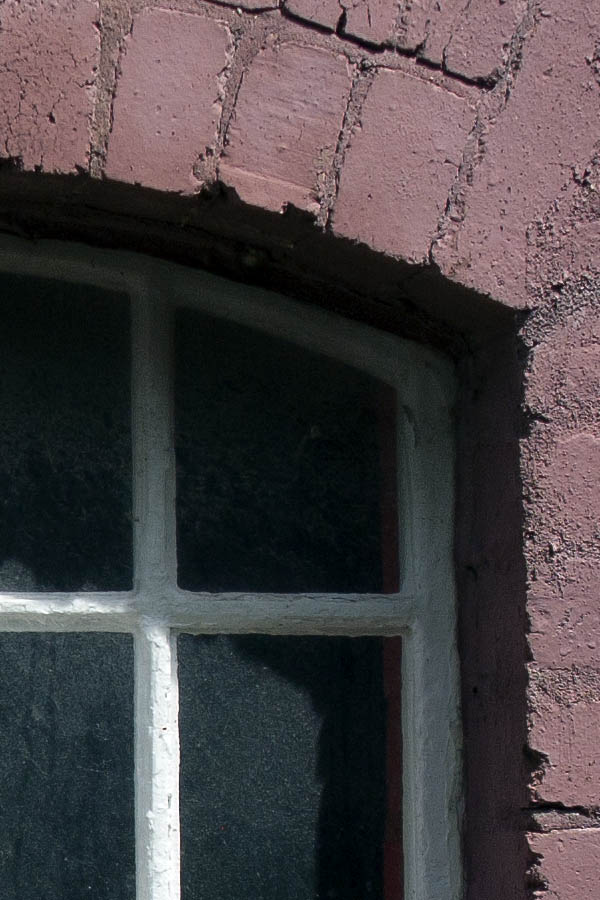 Photo 04946: White, formed, metal window in a cerise wall
