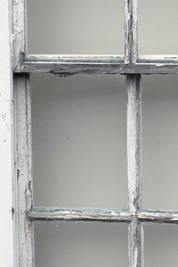 Photo 05189: Worn, white sash window with 12 panes