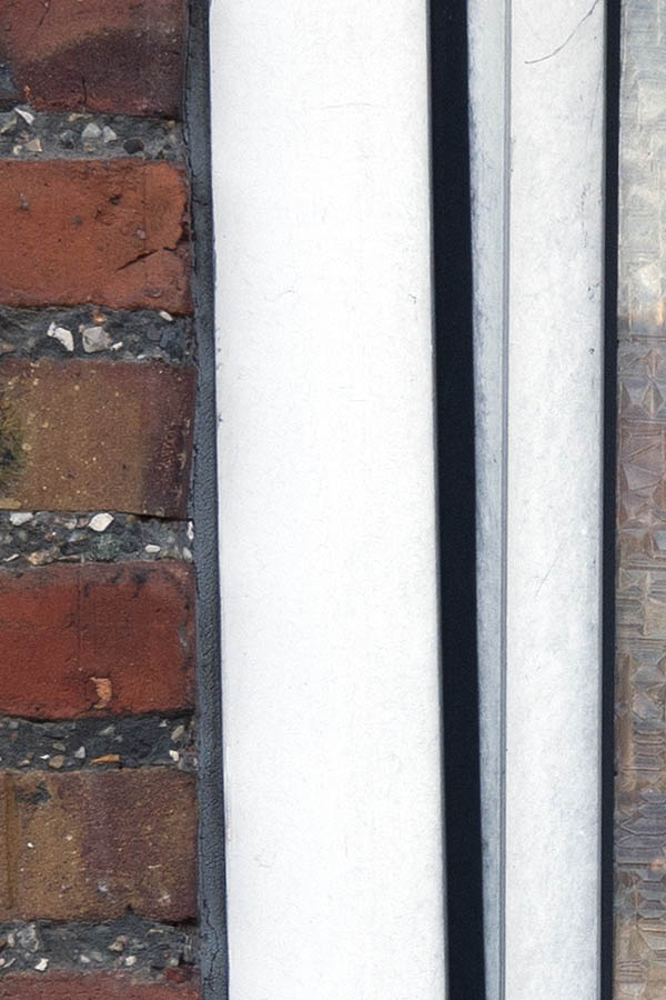 Photo 08185: Lopsided, worn, white plastic window