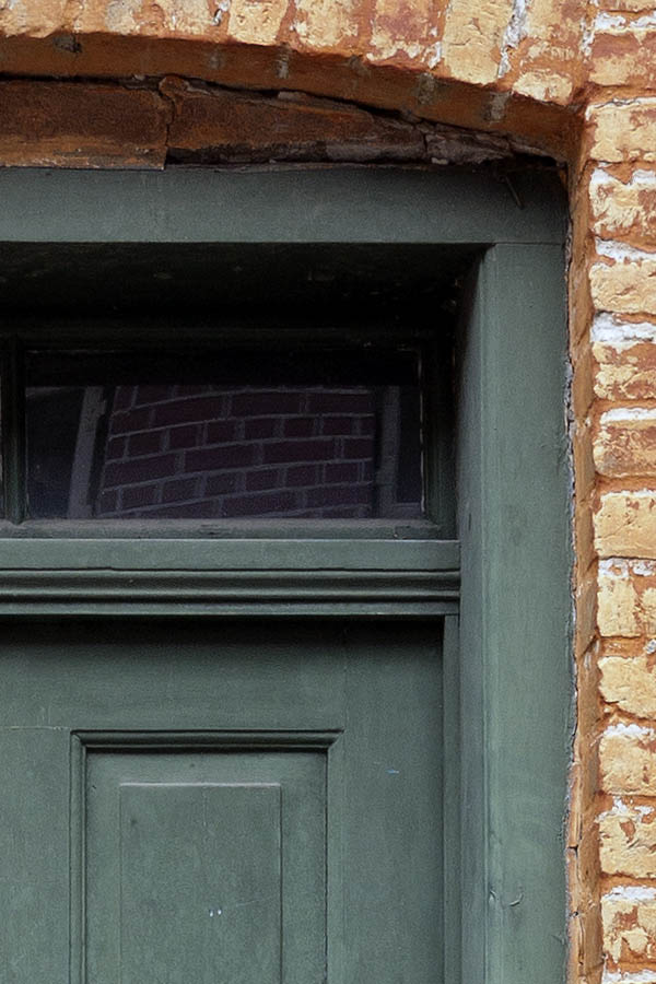 Photo 09040: Worn, panelled, green door with top window