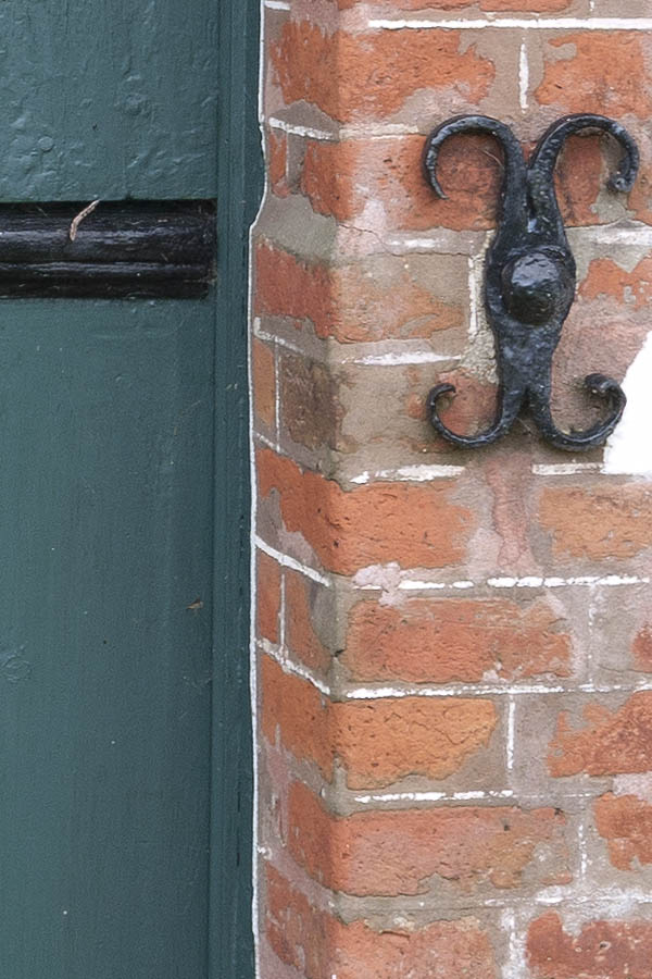 Photo 09681: Formed, teal half-door made of planks with a round door light