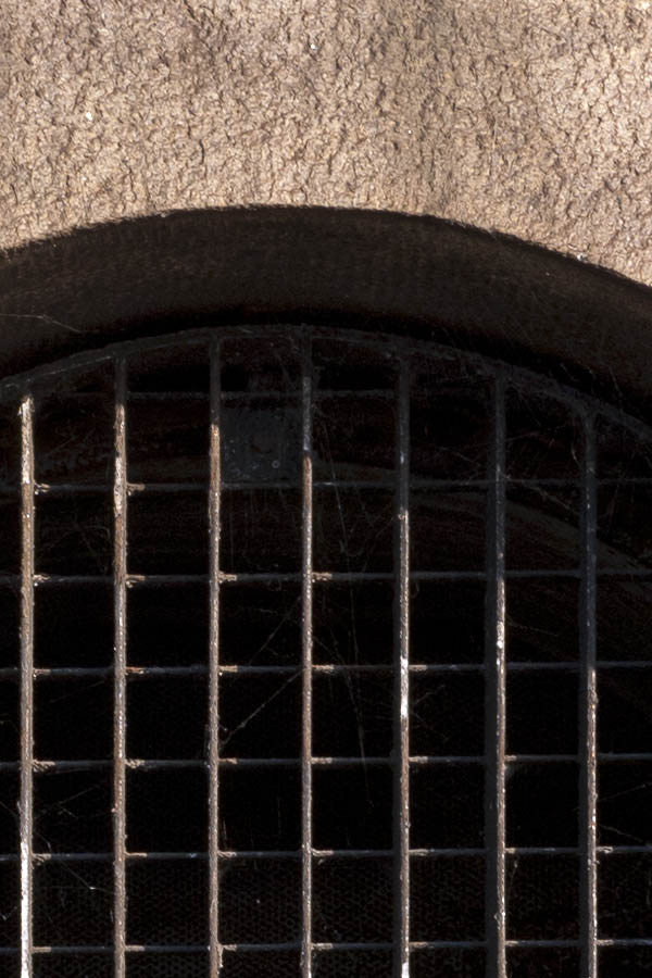 Photo 10734: Round, brown metal venthole window