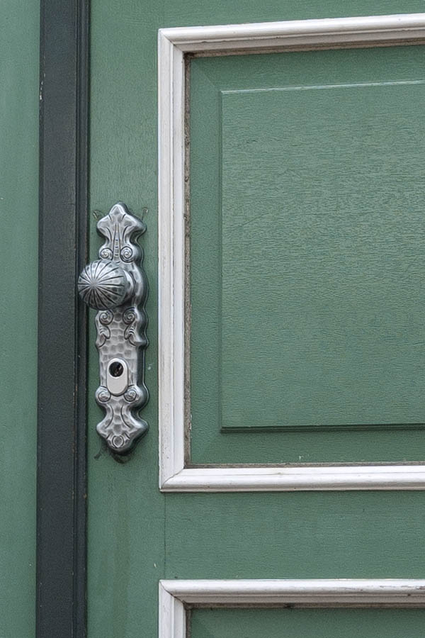 Photo 11999: Panelled, green and white door with sidepiece and carved, red and grey pilaster