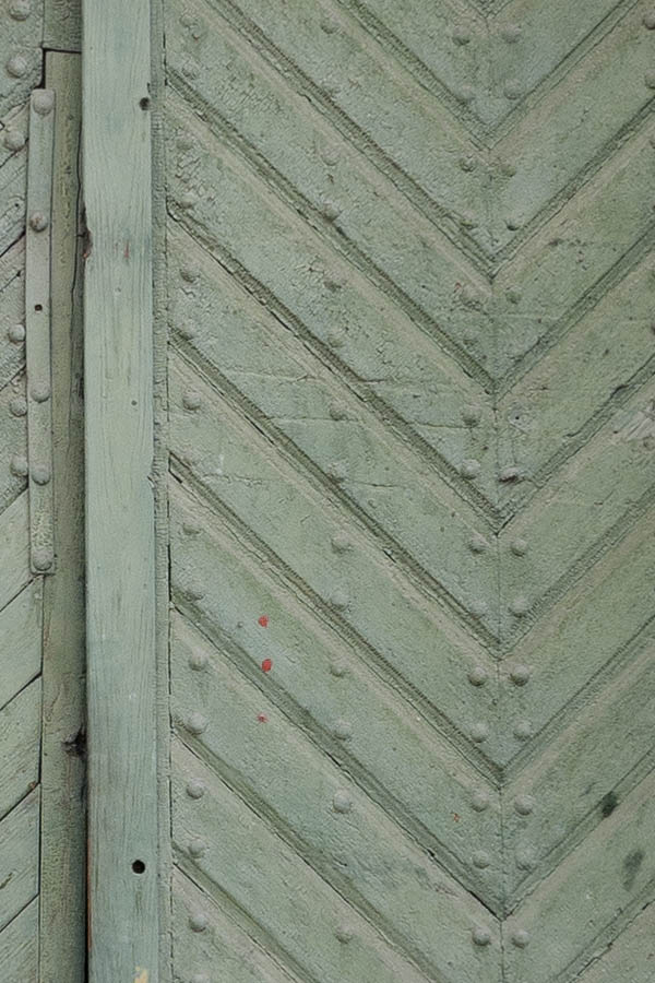 Photo 14383: Worn, panelled, formed, light green gate with minor door.