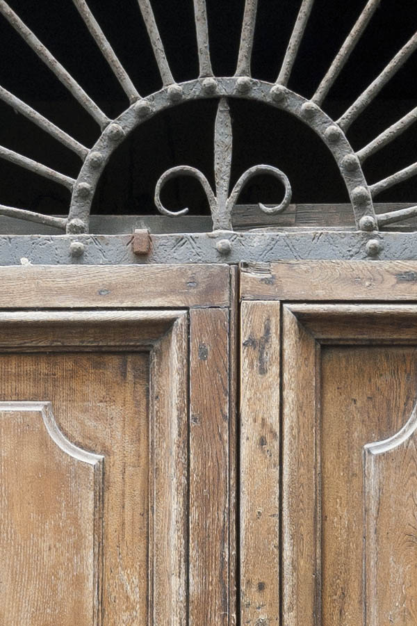 Photo 14991: Worn, panelled, brown double door with latticed fan light
