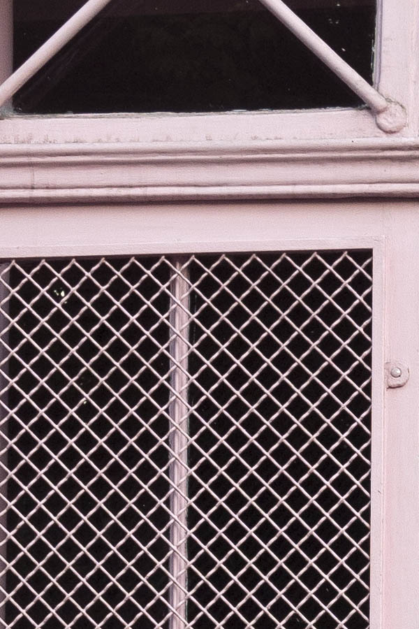 Photo 15529: Panelled, pink double door with large, latticed door lights and barred top windows