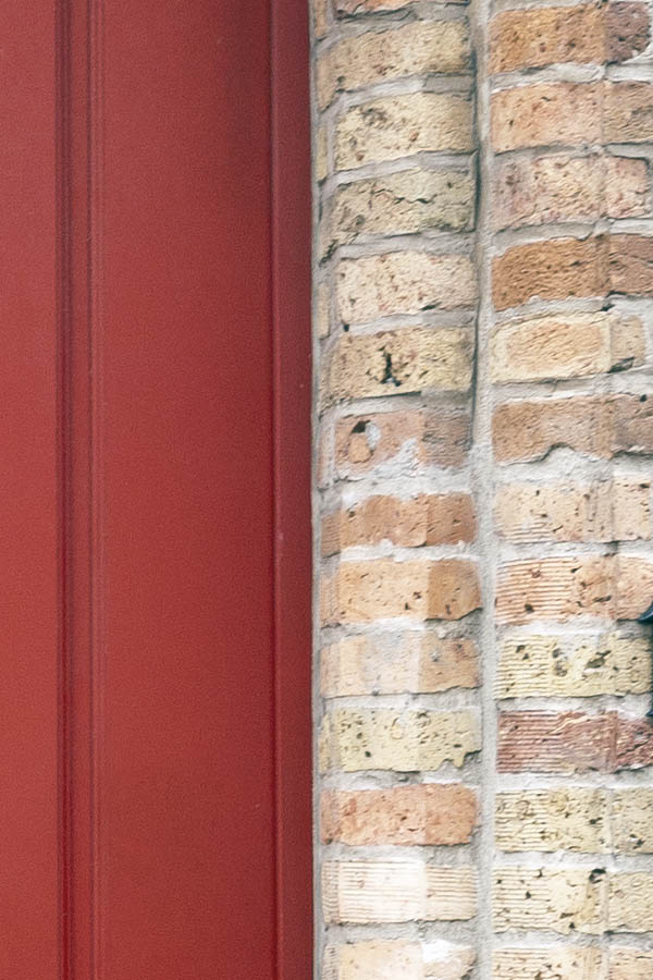 Photo 16095: Red door made of planks with a red and white, barred top window