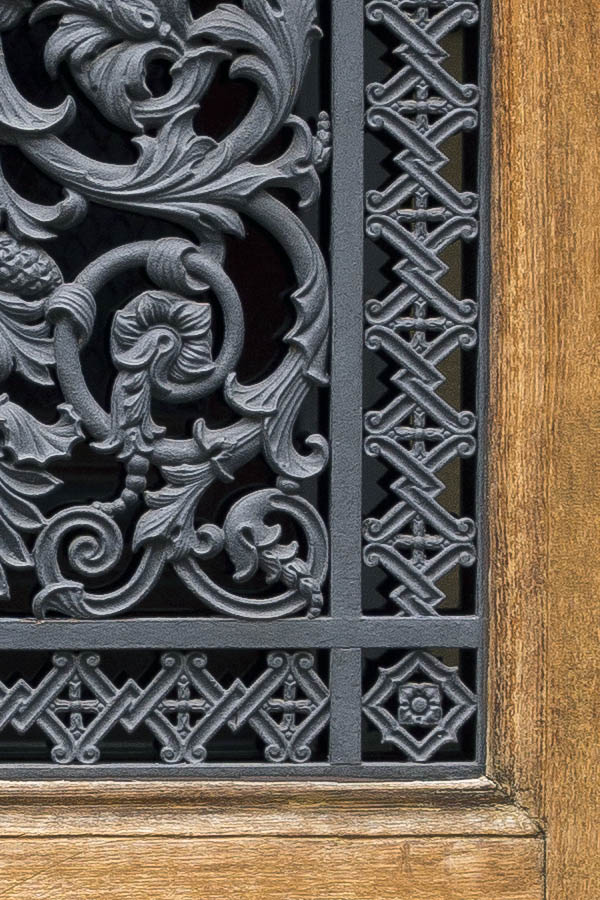 Photo 23849: Worn, unpainted, panelled door with cast-iron lattice
