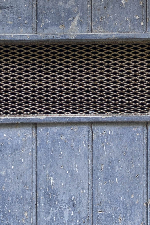 Photo 24454: Worn, blue gate of boards with latticed door lights
