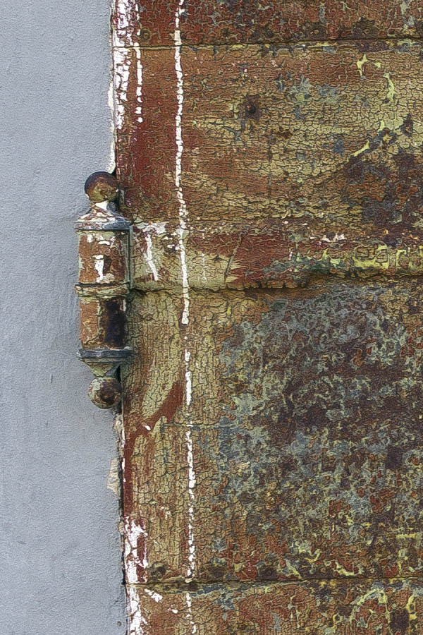 Photo 25351: Worn, brown, unpainted gate of metal plates