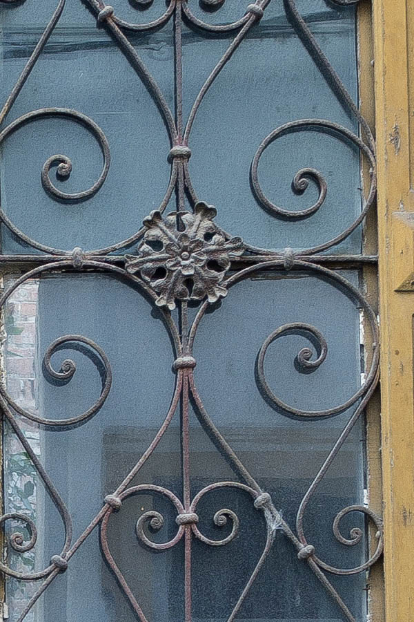 Photo 25819: Decayed, panelled, carved, yellow double door with latticed door lights and broken top window