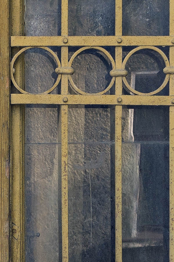 Photo 25858: Worn, narrow, panelled, carved, yellow double door with latticed door lights