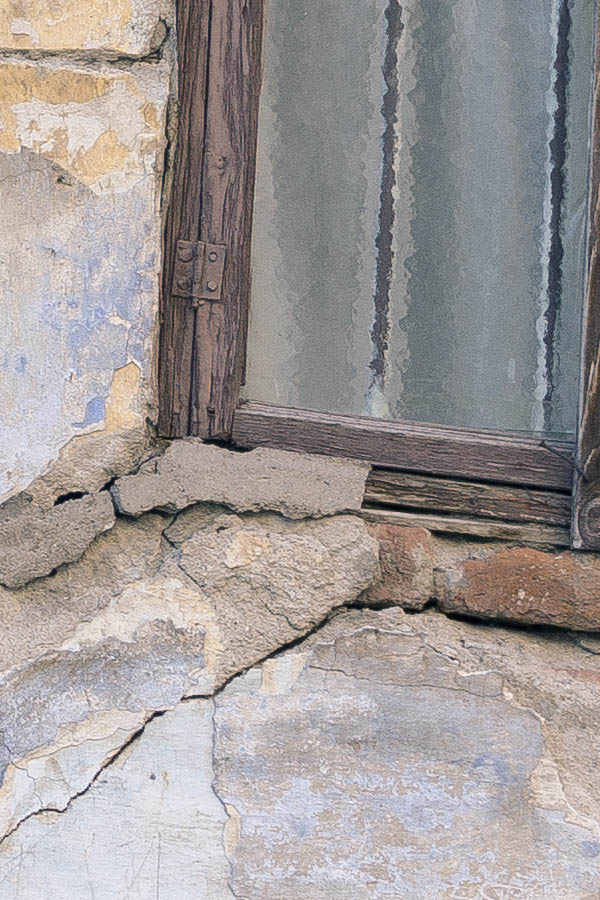 Photo 26367: Facade with low, brown door and a lopsided, brown window