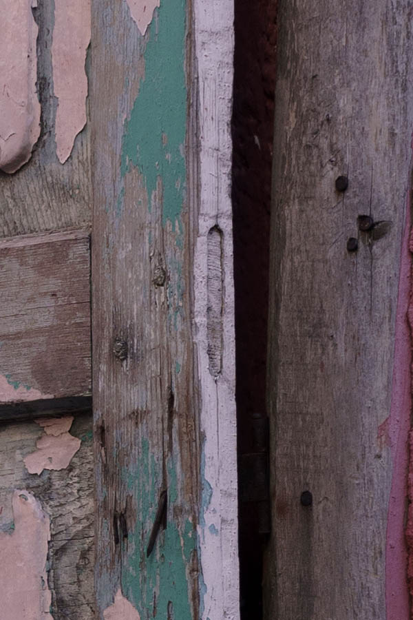 Photo 26459: Decayed, pink, panelled door leading to a yard