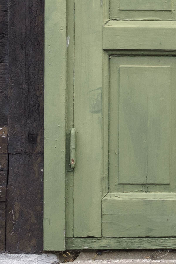 Photo 27086: Facade with green, panelled double door and two windows with two frames and four panes each