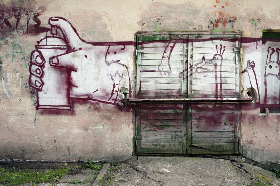 Photo 13332: Worn green double door of boards with large grafitti drawing