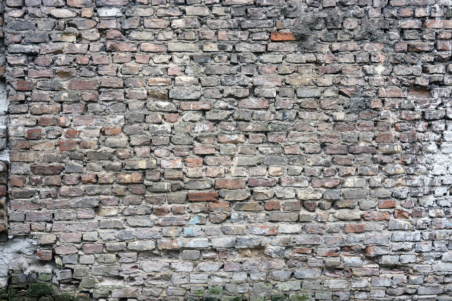Photo 19171: Worn brick wall with yellow, red, black and blue bricks
