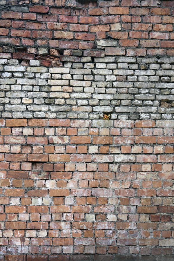 Photo 19175: Worn wall made of red, white and orange bricks