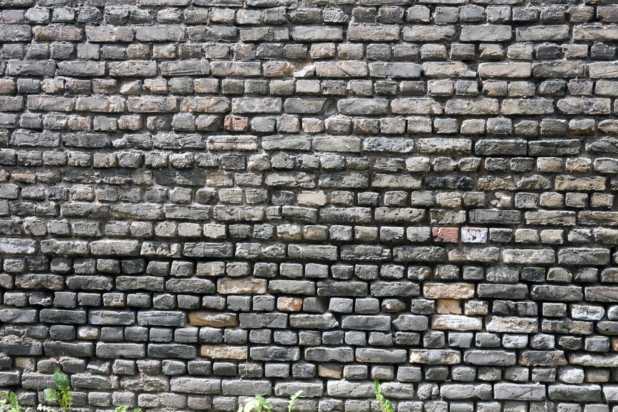 Photo 19299: Worn brick wall with yellow and black bricks