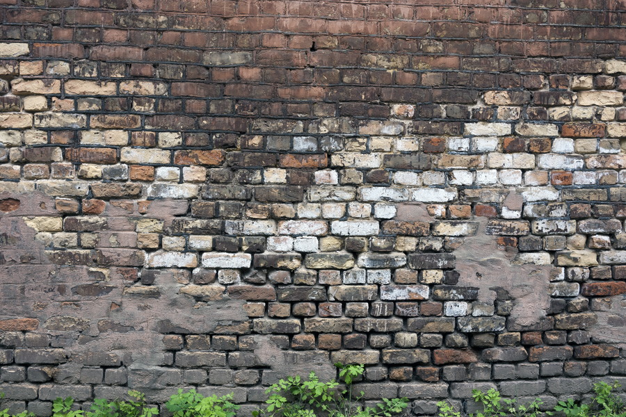 Photo 19301: Worn brick wall with red, white and brown bricks