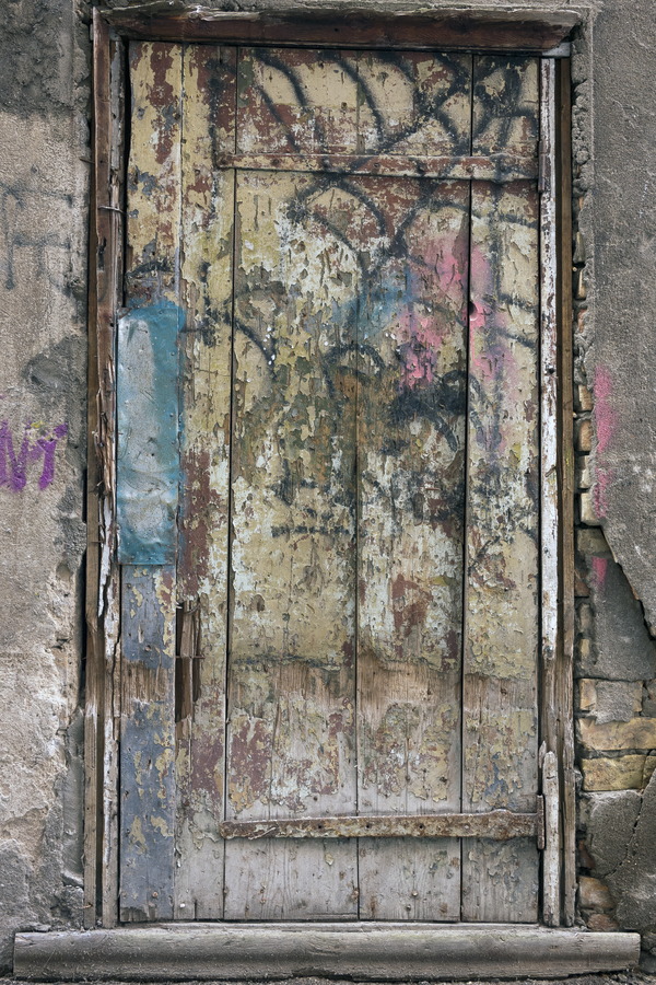 Photo 19510: Decayed, light green door of planks with grafitti