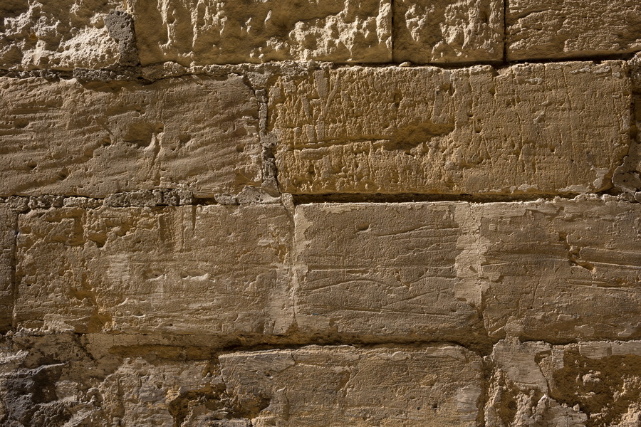 Photo 24104: Worn, yellow sandstone wall