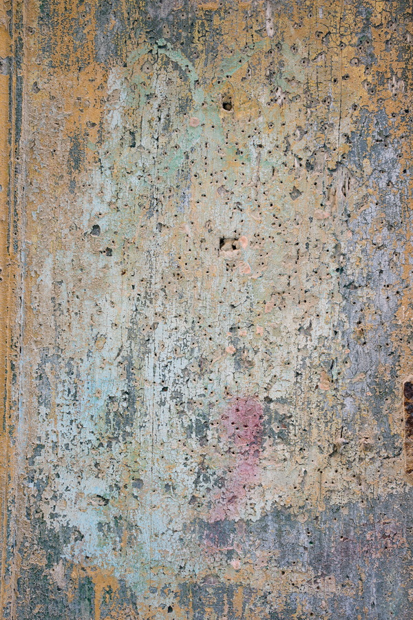 Photo 24314: Worn, plastered wall in yellow, white, light green and red