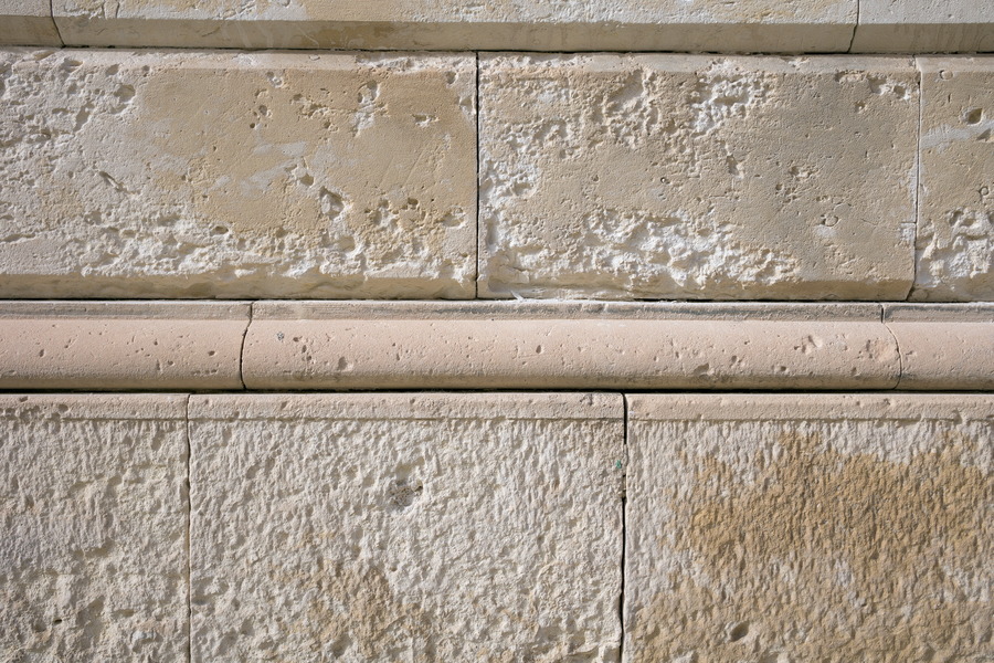 Photo 24397: Worn, yellow sandstone wall