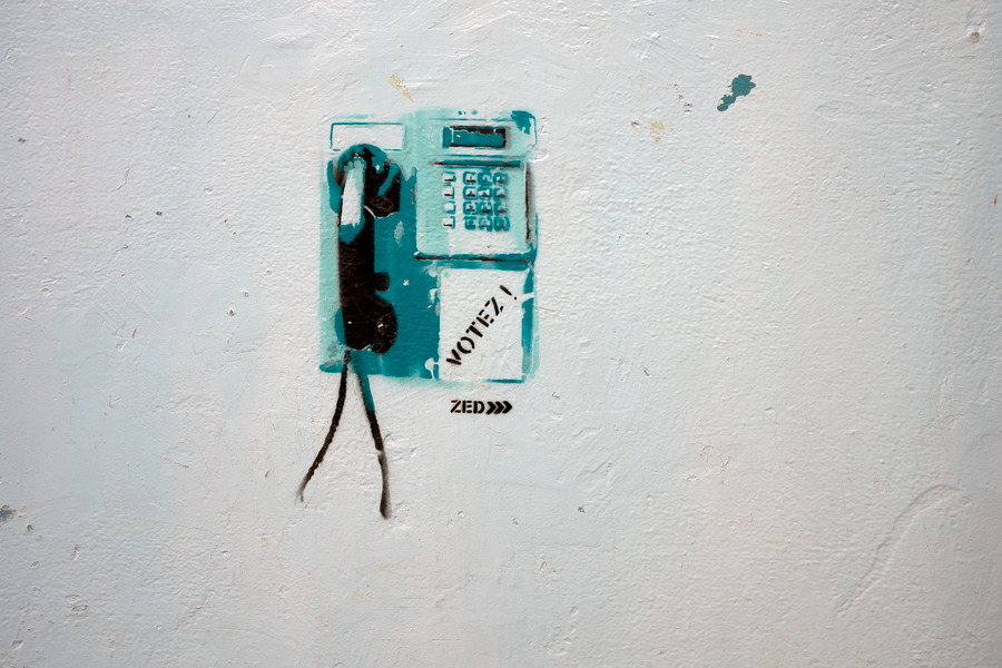 Photo 24486: White, plastered wall with telephone grafitti 