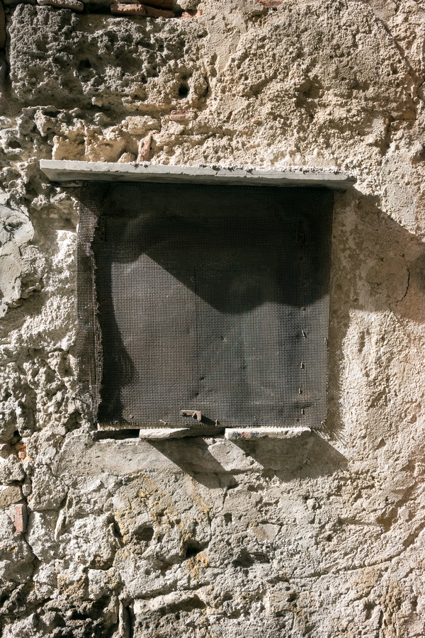 Photo 24605: Decayed, light brown wall with latticed window