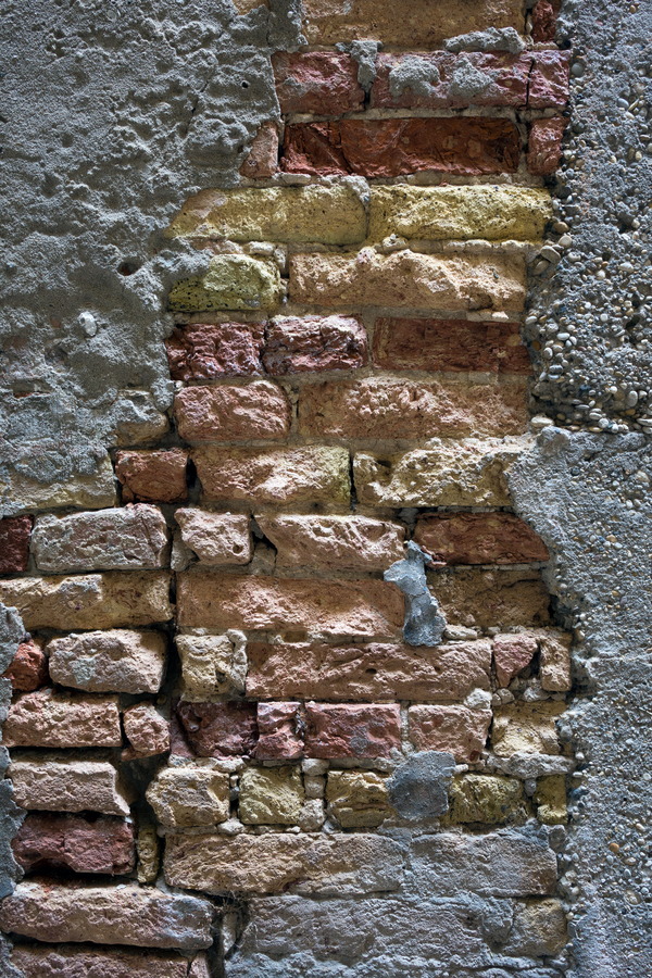 Photo 24769: Decayed, plastered brick wall in grey, yellow and red colours