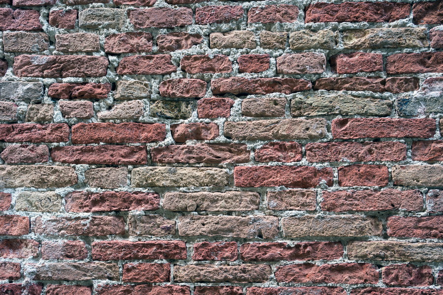 Photo 24790: Worn brick wall in red and yellow colours