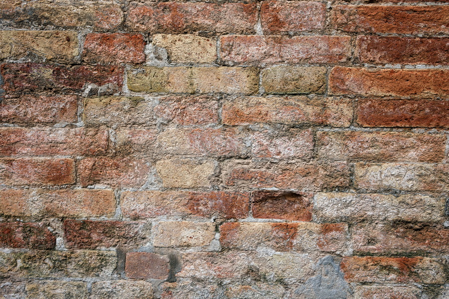 Photo 24804: Worn brick wall in red and yellow colours.