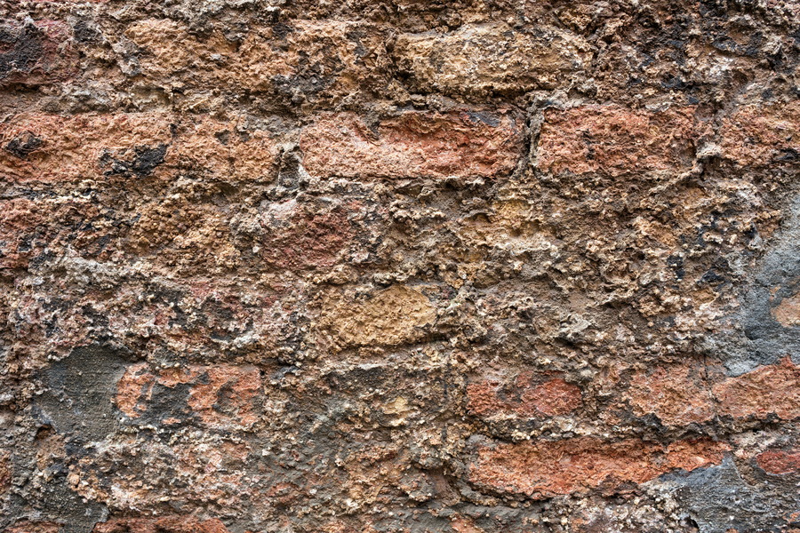 Photo 24805: Worn, plastered brick wall in red and yellow colours