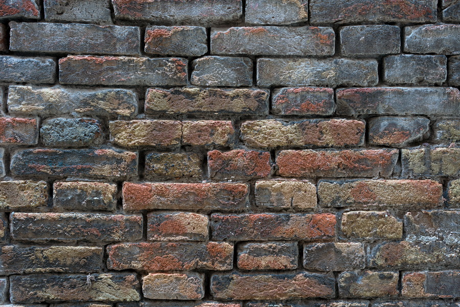 Photo 24816: Worn brick wall without mortar in blue, yellow and red colours