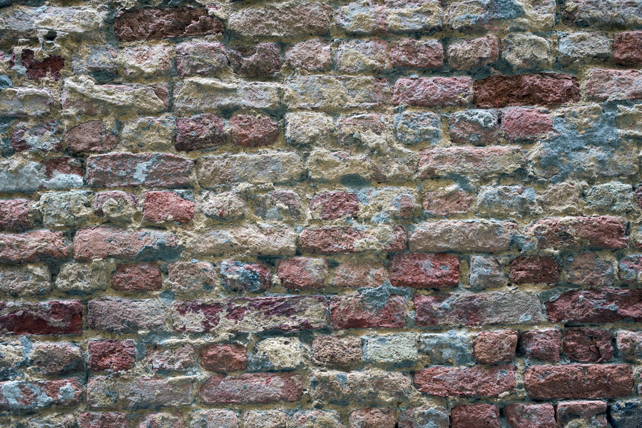 Photo 24832: Worn brick wall in yellow, red and blue colours