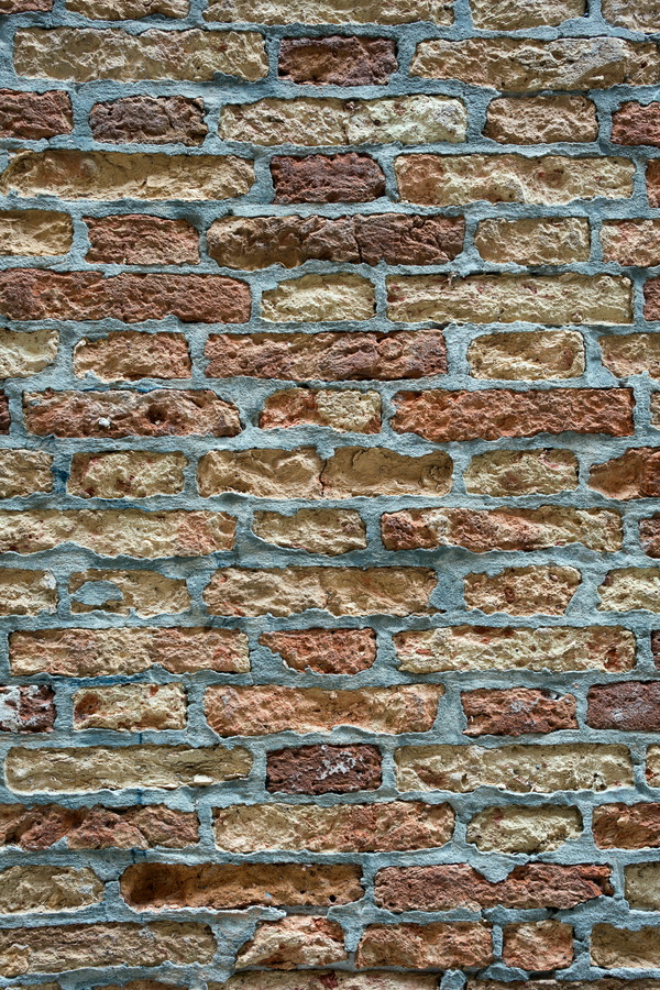 Photo 24852: Worn brick wall in yellow and red with grey or blue mortar