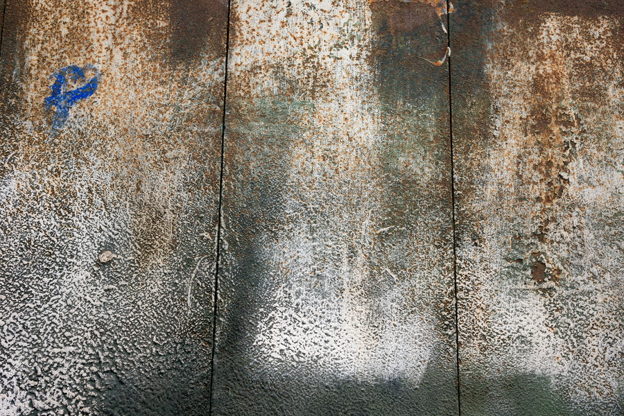 Photo 24857: Worn wall of planks in white, black and brown