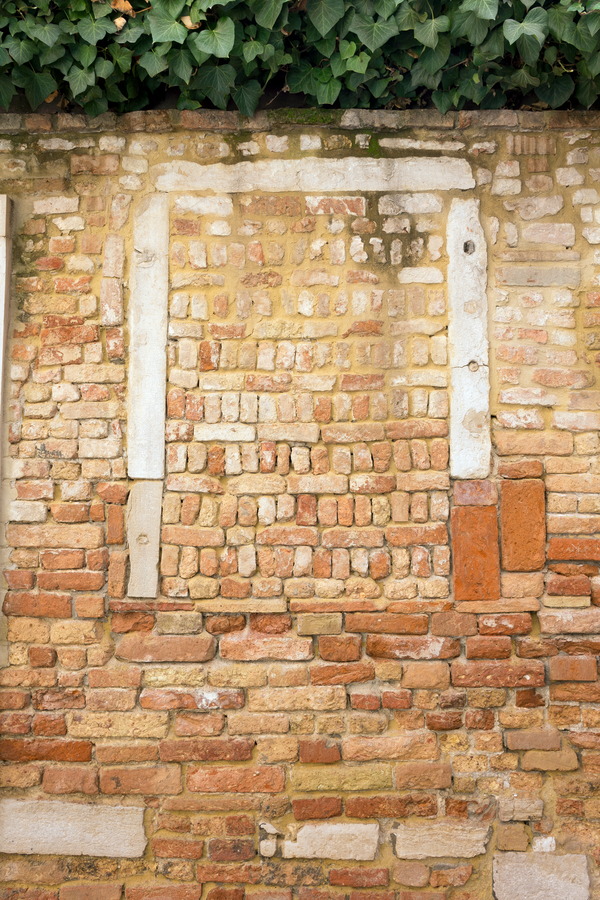 Photo 24872: Worn, red and yellow brick wall with remains of a window